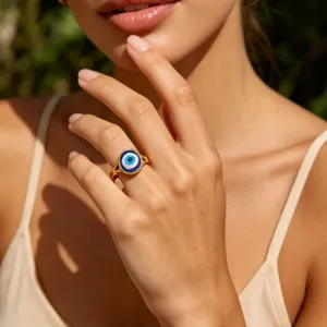 Gold plated stainless steel evil eye ring with blue enamel accent for elegant daily wear.