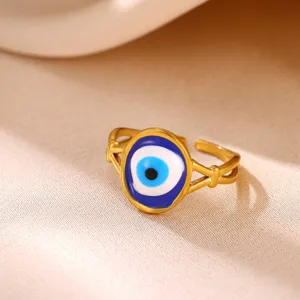 Gold stainless steel evil eye open ring detailed close-up shot showcasing blue enamel.