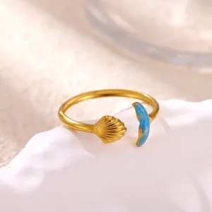 Gold stainless steel open ring detail featuring a delicate shell and blue oil drop design.