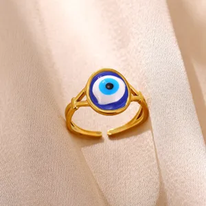Closeup of stylish gold plated adjustable ring featuring a vibrant blue evil eye charm detail.