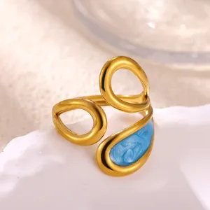 Gold plated stainless steel open ring featuring blue enamel detail, elegant design.