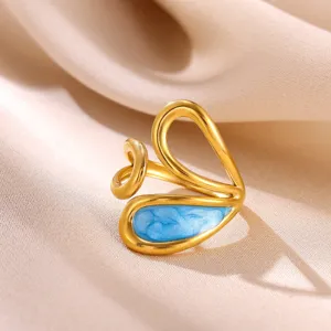 Close-up detail of 18K gold plated stainless steel open ring with blue enamel heart design.
