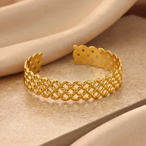 Gold minimalist geometric open cuff bracelet detail view, elegant fashion jewelry accessory.