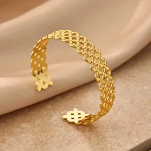 Gold geometric mesh open cuff bracelet detail view, elegant hollow design fashion jewelry.