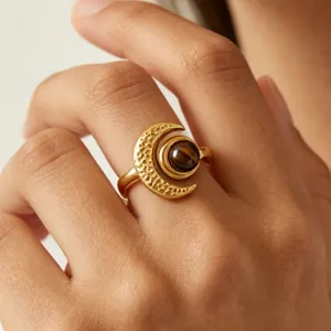 Detail shot of 18K gold stainless steel moon ring with amber, elegant fashion jewelry for women.