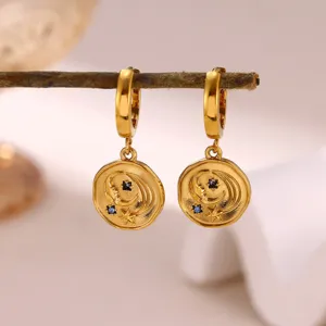 Gold plated stainless steel hoop earrings featuring celestial moon and star coin pendants.