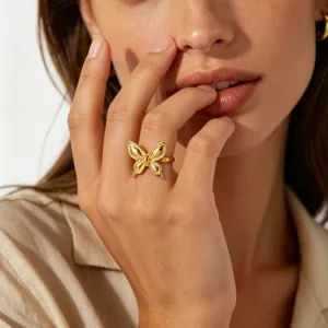 Gold butterfly ring detail close up shot, elegant stainless steel fashion jewelry for women.