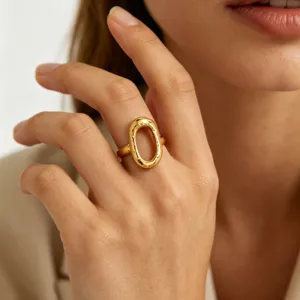 Close-up detail of a bold 18k gold plated open ring with unique textured design.