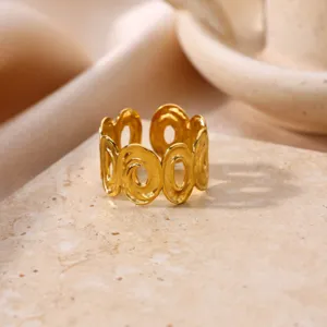 Detailed shot of a chic geometric hollow gold-plated open ring with French retro vibe.