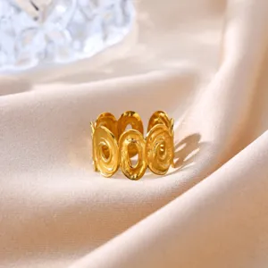Detailed close-up of a French vintage gold-plated geometric open ring on satin fabric.