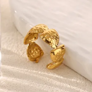 Gold stainless steel leaf ring detail shot, vintage open geometric design jewelry piece.