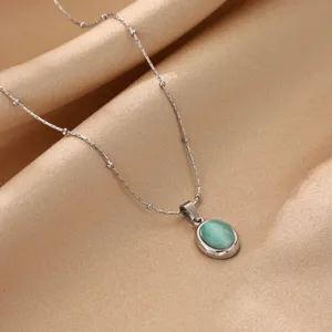 Minimalist titanium steel necklace with oval green cat's eye pendant for women daily wear.