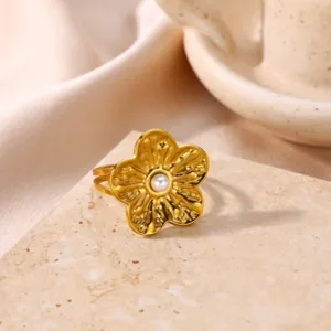 Close-up detail shot of retro sunflower open ring with pearl center in gold finish.