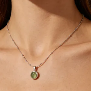 Minimalist titanium steel oval cat eye pendant necklace, elegant clavicle chain jewelry item.