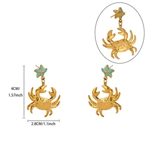 Close-up detail of gold crab and starfish earrings featuring sparkling rhinestones and blue enamel.