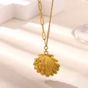 Gold shell starfish pendant necklace, delicate mixed chain clavicle jewelry detail shot.