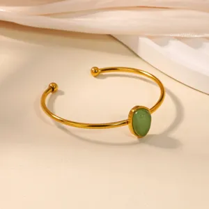 Minimalist 18K gold plated stainless steel open cuff bangle featuring a chic green stone.