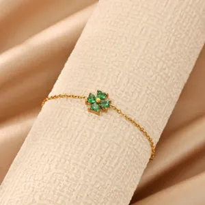 Green clover zircon bracelet detail view showing delicate gold chain and sparkling pendant.
