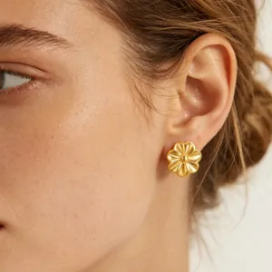 Gold flower stud earrings detail view, elegant heart-shaped petal design for women.