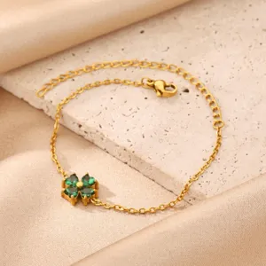 Close-up detail of the 18K gold plated stainless steel green clover bracelet pendant.