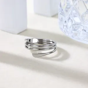 Close-up of minimalist multi-layer silver stainless steel open ring detail view.