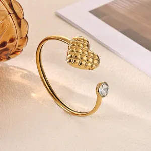 Exquisite 18k gold plated open cuff bracelet featuring a quilted heart and sparkling stone detail.