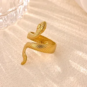 Close-up detail of a gold snake ring with textured scales, elegant open wrap design for women.