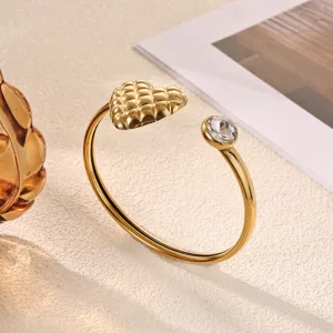 Exquisite 18K gold plated stainless steel cuff bracelet featuring a quilted heart and crystal.
