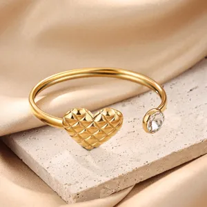 Elegant 18k gold plated stainless steel open cuff bracelet featuring a quilted heart and crystal.