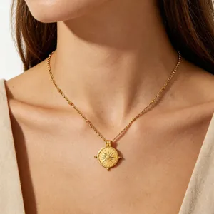 Close-up detail view of the exquisite gold-plated sun compass pendant necklace worn on neck.