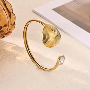 Stainless steel 18K gold plated cuff bracelet detail view featuring textured geometric dome.