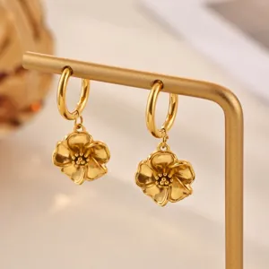 Gold flower dangle hoop earrings detail shot showcasing the delicate metal petals and polished ring.