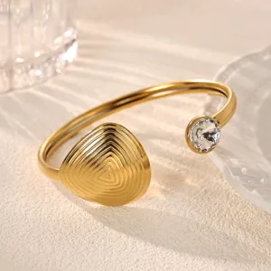 18k gold plated open cuff bracelet with geometric triangle design and sparkling cubic zirconia.