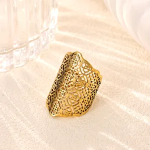 Close-up of a gold-plated stainless steel hollow ring featuring an intricate lace pattern.