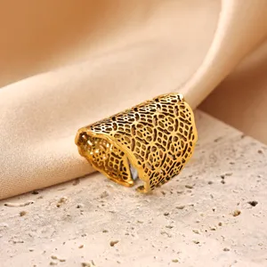 Detailed view of a wide gold stainless steel open ring featuring an intricate hollow mesh pattern.