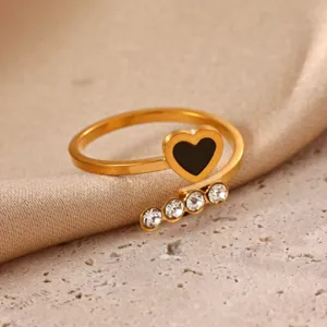 Gold stainless steel open ring featuring a black heart and sparkling crystal details close-up.