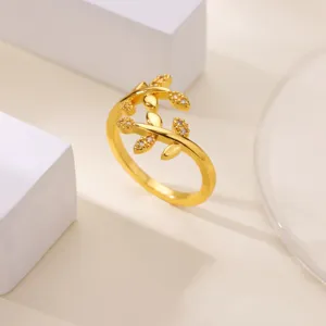 Gold plated leaf branch open ring detail shot, minimalist design with shiny clear zirconia stones.