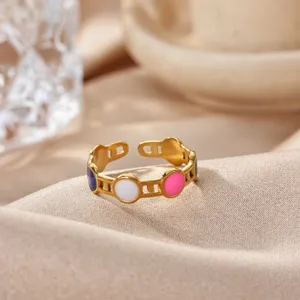 Gold stainless steel open ring with colorful enamel circles, exquisite detail shot of jewelry.