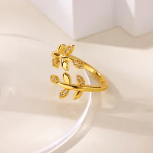 Close-up detail view of the elegant gold-plated leaf branch open ring sparkling with cz stones.