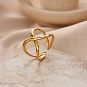 Detail view of a stylish 18k gold plated stainless steel cross open ring for women.