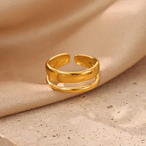 Gold minimalist double layer open ring close-up, elegant metallic texture detail view.