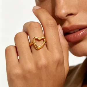 Close-up detail shot of a stylish 18k gold plated open heart ring showcasing the minimalist hollow design.