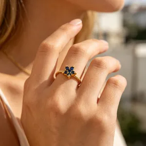 Elegant 18k gold plated flower ring with sparkling blue cubic zirconia for women detailed view.