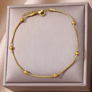 Exquisite 18k gold plated snake chain anklet with delicate beads, elegant detail shot.