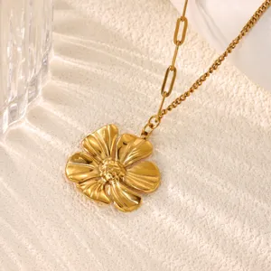 Close-up of golden flower pendant necklace detail, elegant metallic texture and chain link.