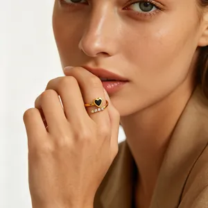 Detailed view of an 18k gold plated stainless steel open ring featuring a black heart and stones.