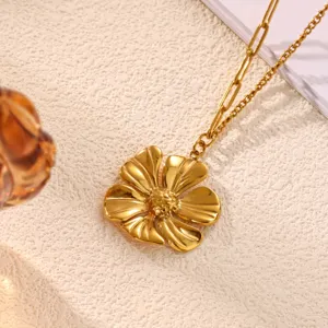 Gold flower pendant necklace close up view, showcasing the detailed metal petals and chain design.