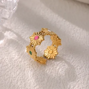 Detail view of gold stainless steel daisy ring with colorful enamel flower centers.