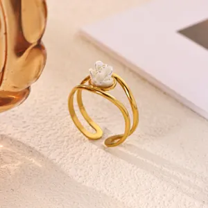 Stainless steel 18K gold plated open geometric ring, delicate white flower detail close-up.