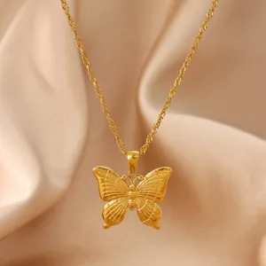 Gold butterfly pendant necklace detail view showing intricate wing texture and fine chain.